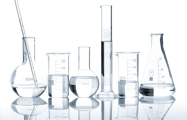 Group of laboratory flasks with a clear liquid, isolated